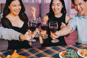 Diversity, dinner and group of people toast celebration together at party. Friends, happy and celebrate with food, wine and friendship for love, support and cheers champagne at business function