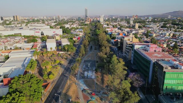 Forward aerial view of Lazaro Cardenas park in urban Guadalajara with roads and green areas