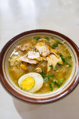 Soto ayam,  a traditional Indonesian dish, in street food restaurant. Soto ayam is also popular in Singapore and Malaysia