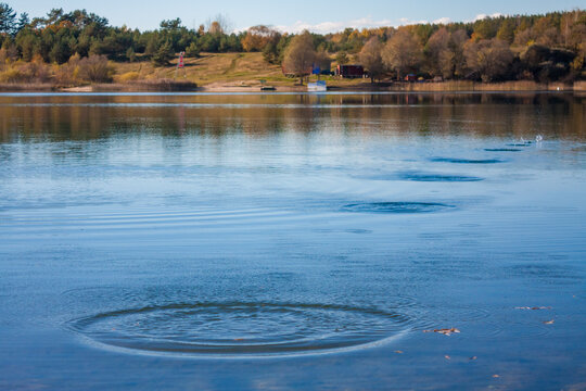 Ripples and splashes on water surface from skipping stones