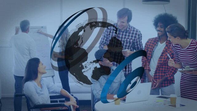 spinning globe ring revealing coworkers collaborating on project around round table updating notes