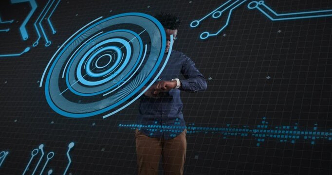 Tech operator raising left arm to smartwatch while tapping ring interface and analyzing binary data