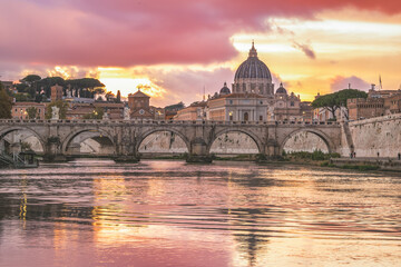 Stunning sunset view of St. Peter&rsquo;s Basilica and Ponte Sant&rsquo;Angelo reflecting in the Tiber River in Rome, Italy.