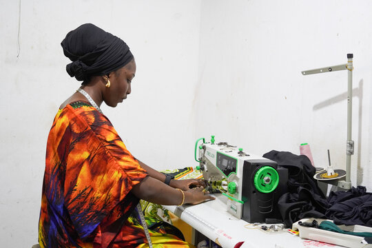 A beautiful African female fashion designer working in her studio