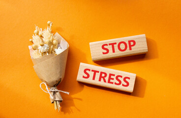 Stop Stress symbol. Wooden blocks with words Stop Stress. Beautiful orange background. Business and Stop Stress concept. Copy space.