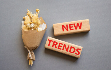 New Trends symbol. Wooden blocks with words New Trends. Beautiful grey background. Business and New Trends concept. Copy space.