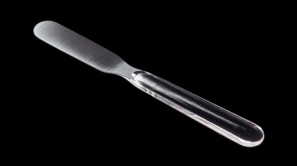 Close-up of a knife with a long, slender blade. the blade is made of stainless steel and has a textured surface with ridges and grooves.