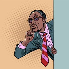 Pop Art Retro A businessman gives a sign to keep quiet. A secret for business and work. Concealing personal data and confidentiality.
