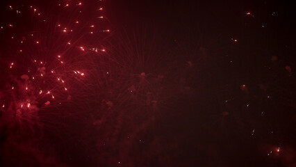 Red Fireworks Glow in Festive Night Sky