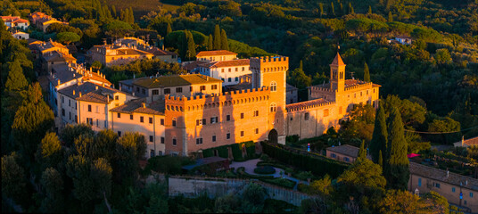 Italy, Idyllic traditional towns of romantic Tuscany. Picturesque borgo Bolgheri medieval village and castle . Panoramic drone view over sunset