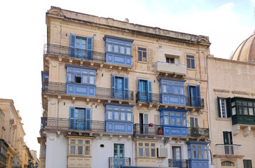 View of old building with windows, balconies in city. Republic of Malta, the picturesque city of Valetta, Malta.