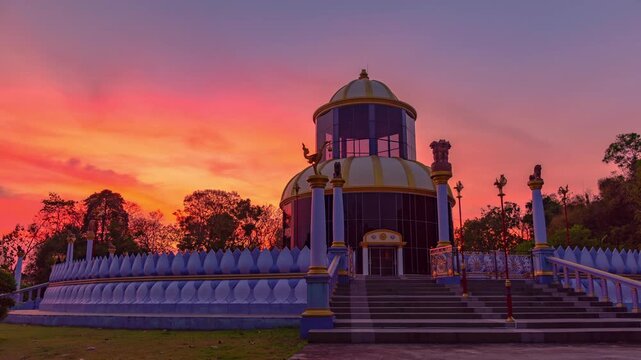 Time lapse amazing pink sky at sunset behind the beautiful pagoda of wat Khao Kog beside Cadet Academy Nakhon Nayok Thailand. The dome-shaped pagoda, modeled after one from India