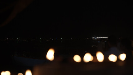 Diyas glow softly in the dark at the Ganga Ghat in Kashi during Dev Deepawali.