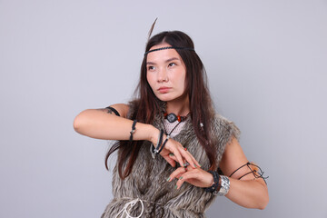 Shaman woman in feather headdress on light grey background