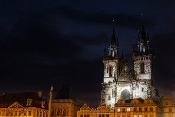 Fototapeta premium Illuminated Gothic cathedral at night in Prague, Church of Our Lady before Týn on the Old Town Square