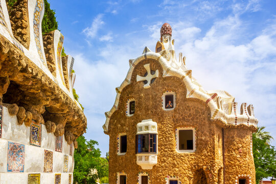 Barcelona, Spain - June 13, 2025: A view of Porter's Lodge Pavilion at Park Guell, showing a mosaic wall on the left side, located in Barcelona, Spain. 