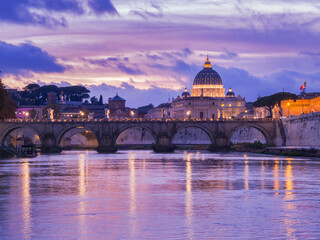 Stunning sunset view of St. Peter&rsquo;s Basilica and Ponte Sant&rsquo;Angelo reflecting in the Tiber River in Rome, Italy.