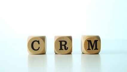 Wooden cubes spelling CRM reflecting modern business customer relationship management concept and strategy for growth