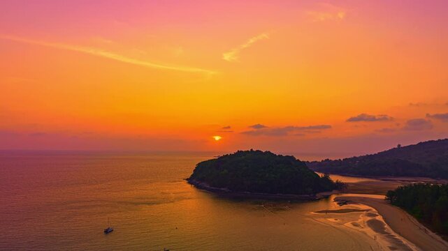 
Aerial hyperlapse view of Crimson Clouds Floating Above the island, romantic glow over the horizon. Serene Paradise Sunset by the Sea at Kala island Layan beach. Colorful Evening Glow by the Beach