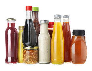 Bottles and jars with different tasty sauces isolated on white