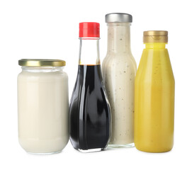 Bottles with different tasty sauces isolated on white