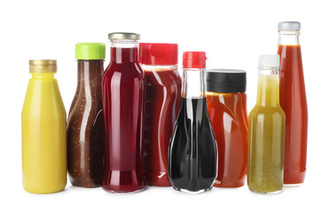 Bottles with different tasty sauces isolated on white