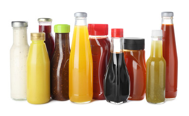 Bottles with different tasty sauces isolated on white