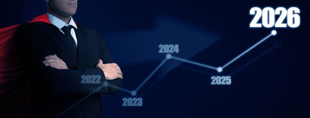 Businessman in superhero cape and graph with numbers of years from 2022 to 2026 against dark blue...