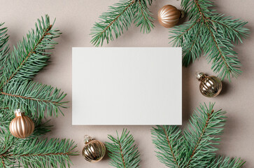 Christmas or New Year greeting card mockup with copy space for card design, flat lay with evergreen...
