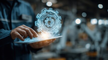 Obraz premium Engineer using tablet to control automated machinery in modern manufacturing facility