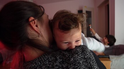 Mother holding baby on shoulder, calm and affectionate moment showing connection, tenderness, and comfort in everyday family life at home