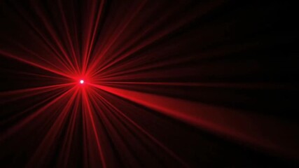 Spinning red and green laser swirl beams glowing on dark abstract background