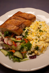Delicious morning breakfast, Rustic breakfast featuring scrambled eggs and fresh salad, Comforting weekend meal with scrambled eggs and vibrant salad