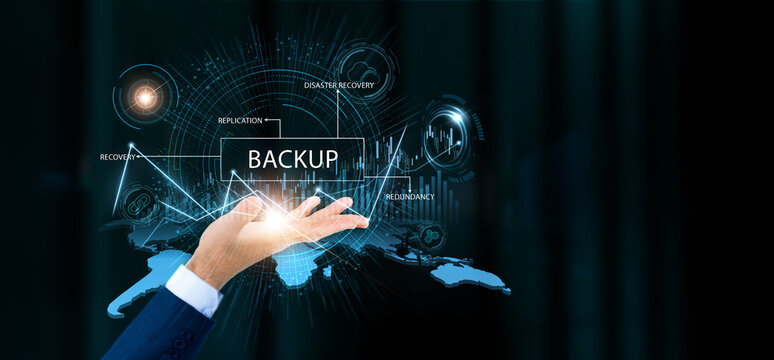 Businessman hold backup words and growth technology and data connection. Cloud storage, data recovery, system protection, digital security management. - Powered by Adobe