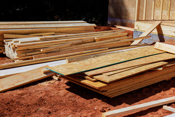 Wooden planks beams sheets are neatly piled at construction site
