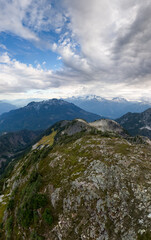 Majestic Alpine Ridge Above Rocky Crags and Forest, Vast Cloudscape Over British Columbia, Canada Scenic