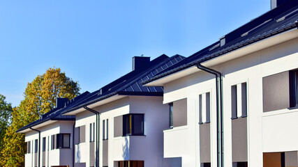 Harmony with nature, eco architecture. Terraced single family homes in newly developed housing estate. The real estate market in the suburbs with lush greenery surrounding. 