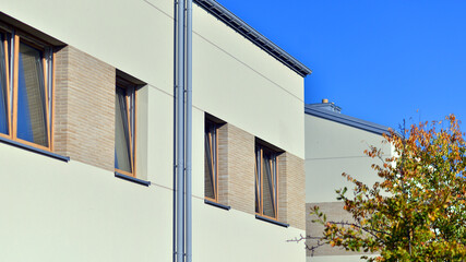 Harmony with nature, eco architecture. Terraced single family homes in newly developed housing estate. The real estate market in the suburbs with lush greenery surrounding. 