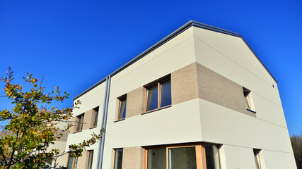 Harmony with nature, eco architecture. Terraced single family homes in newly developed housing estate. The real estate market in the suburbs with lush greenery surrounding. 