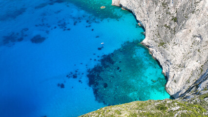 Aerial drone photo of white beach consisting of volcanic caves and white steep hill near famous...