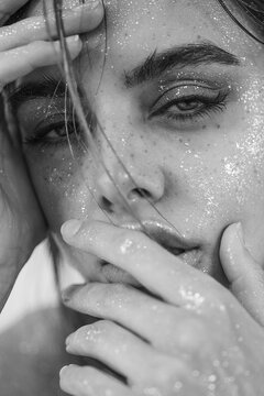beautiful woman with natural makeup, wet hair, and sparkling glitter on her skin. The image evokes a sensual, artistic, and glamorous mood, perfect for beauty, skincare concepts.