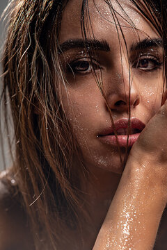 beautiful woman with natural makeup, wet hair, and sparkling glitter on her skin. The image evokes a sensual, artistic, and glamorous mood, perfect for beauty, skincare concepts.