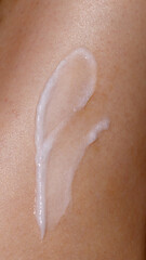 Close-up of a smooth smear of skincare cream applied on a woman&rsquo;s skin.
