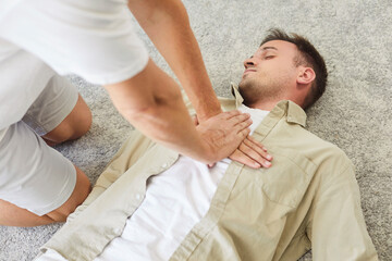 CPR chest compressions assist patient in emergency resuscitation. Hands press the chest of an unresponsive unconscious man. A rescuer gives first aid to patient. Lifesaving skills concept.