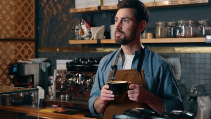 Cheerful happy Caucasian waiter cafe worker barista small business owner holding cup of coffee beverage drink male smile in coffeehouse friendly man in apron greeting client guy waving hand catering
