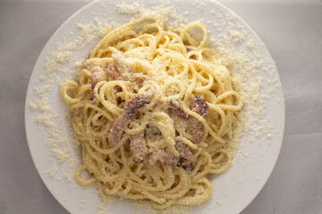 Italian pasta in a white plate close up. Traditional Mediterranean cuisine and homemade culinary recipes.