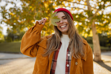young attractive blond woman walking in autumn park, stylish , smiling