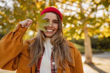 young attractive blond woman walking in autumn park, stylish , smiling