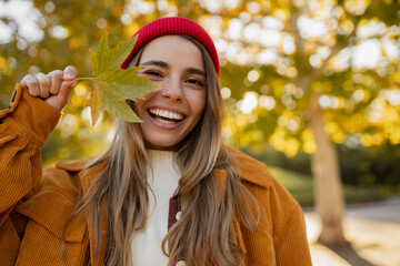 young attractive blond woman walking in autumn park, stylish , smiling