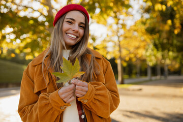 young attractive blond woman walking in autumn park, stylish , smiling
